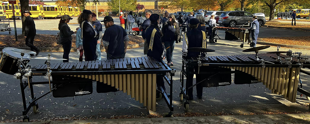 Students and parents stand with mallet percussion instruments